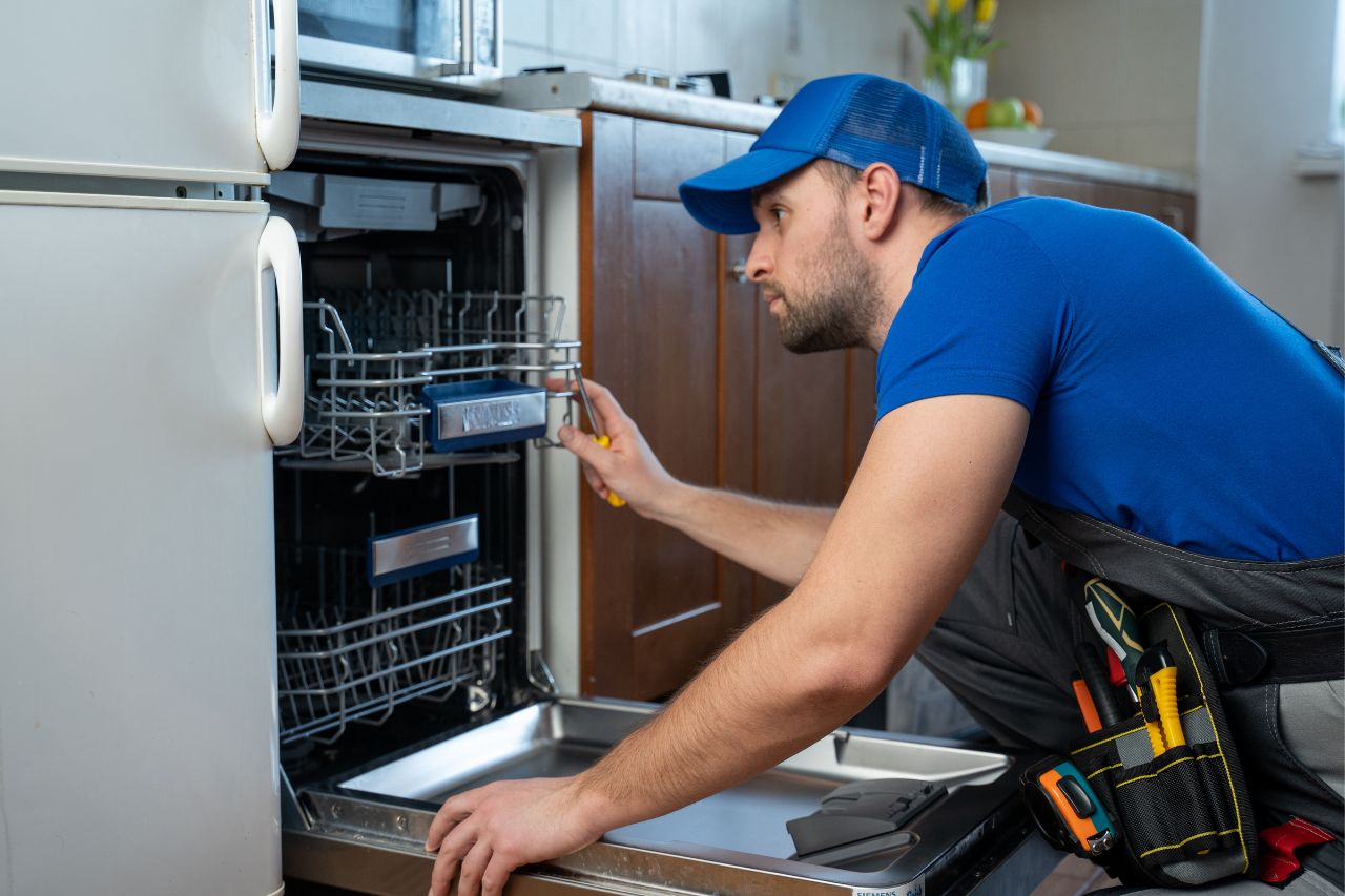 repairman installing dishwasher